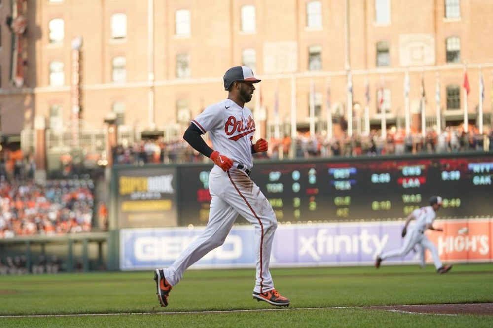 Baltimore Orioles' Aaron Hicks scores from third base on a sacrifice fly ball by Ryan McKenna against the Cincinnati Reds in the second inning of a baseball game, Tuesday, June 27, 2023, in Baltimore. (AP Photo/Julio Cortez)
