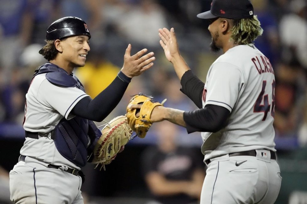 Cleveland Guardians relief pitcher Emmanuel Clase (48) and catcher Bo Naylor celebrate after their baseball game against the Kansas City Royals Tuesday, June 27, 2023, in Kansas City, Mo. The Guardians won 2-1. (AP Photo/Charlie Riedel)