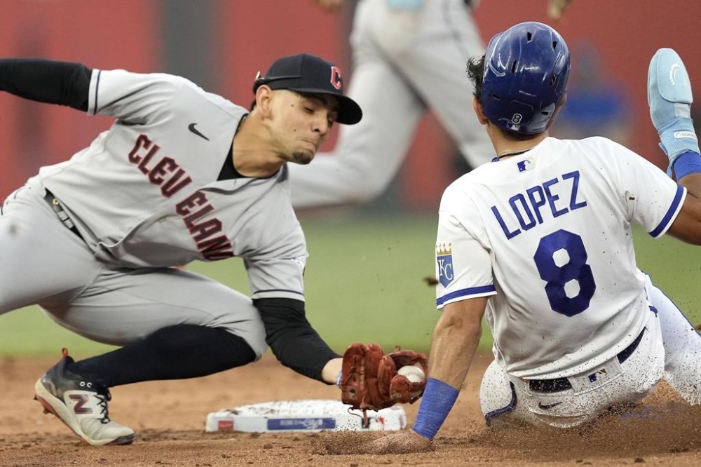 Kansas City Royals' Nicky Lopez (8) is caught stealing second by Cleveland Guardians second baseman Andres Gimenez during the third inning of a baseball game Tuesday, June 27, 2023, in Kansas City, Mo. (AP Photo/Charlie Riedel)