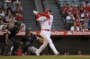 Los Angeles Angels' Shohei Ohtani, right, hits a solo home run as Chicago White Sox catcher Yasmani Grandal, center, and home plate umpire Roberto Ortiz watch during the first inning of a baseball game Tuesday, June 27, 2023, in Anaheim, Calif. (AP Photo/Mark J. Terrill)