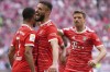 FILE - Bayern's Serge Gnabry, left, celebrates besides team mate Bayern's Noussair Mazraoui and Bayern's Thomas Mueller after scoring his side's opening goal during the German Bundesliga soccer match between FC Bayern Munich and Hertha BSC Berlin at the Allianz Arena stadium in Munich, Germany, on April 30, 2023. Bayern Munich and Qatar Airways said Wednesday June 28, 2023 they are ending a sponsorship deal which caused tension between the German soccer champion and its fans. (AP Photo/Matthias Schrader, File)