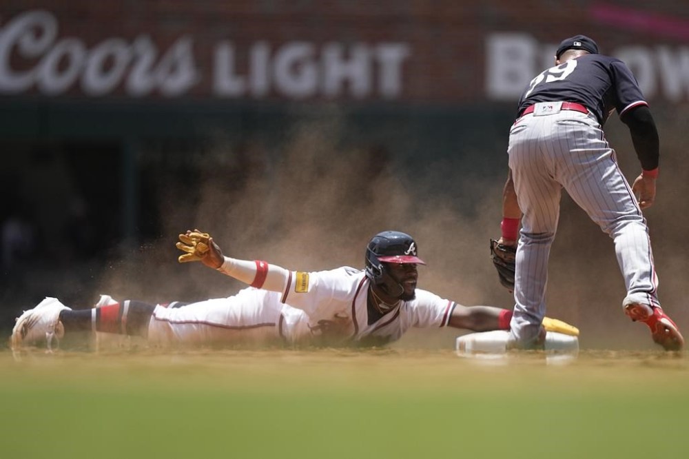 Atlanta Braves' Michael Harris II (23) slides into second base against Minnesota Twins first baseman Donovan Solano (39) in the fifth inning of a baseball game, Wednesday, June 28, 2023, in Atlanta. (AP Photo/Brynn Anderson)