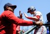 Washington Nationals' Lane Thomas is greeted by manager Dave Martinez after scoring on an RBI double by Jeimer Candelario during the first inning of a baseball game against the Seattle Mariners, Wednesday, June 28, 2023, in Seattle. (AP Photo/Lindsey Wasson)
