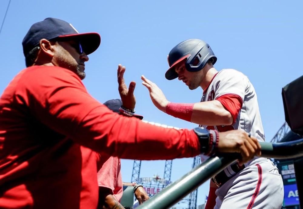 Washington Nationals' Lane Thomas is greeted by manager Dave Martinez after scoring on an RBI double by Jeimer Candelario during the first inning of a baseball game against the Seattle Mariners, Wednesday, June 28, 2023, in Seattle. (AP Photo/Lindsey Wasson)