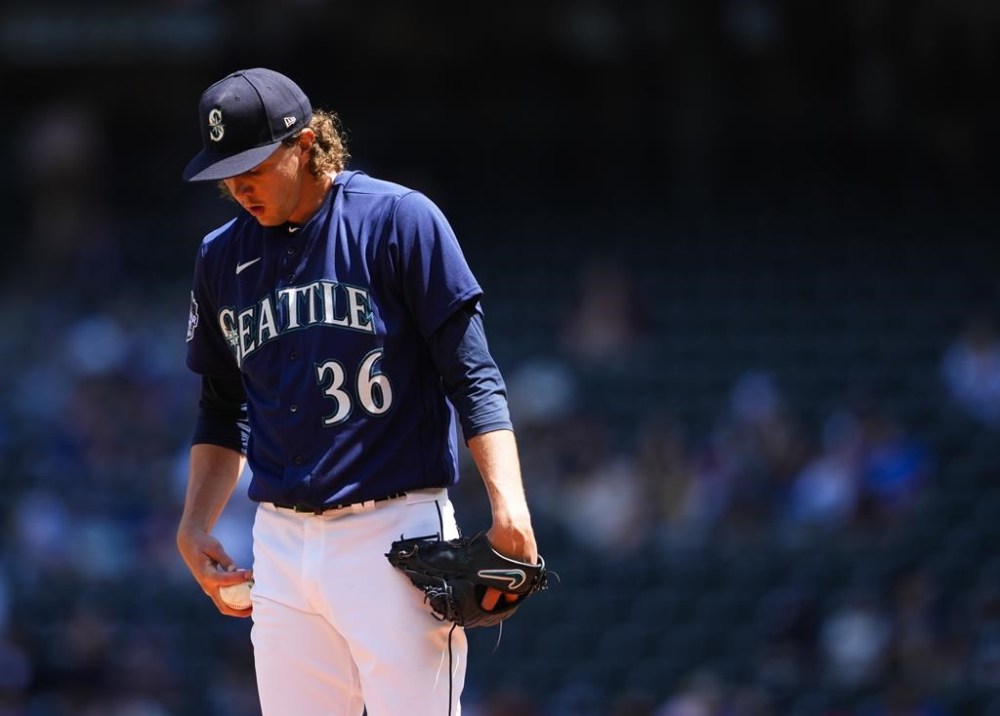Seattle Mariners starting pitcher Logan Gilbert looks down during the first inning of a baseball game against the Washington Nationals, Wednesday, June 28, 2023, in Seattle. (AP Photo/Lindsey Wasson)