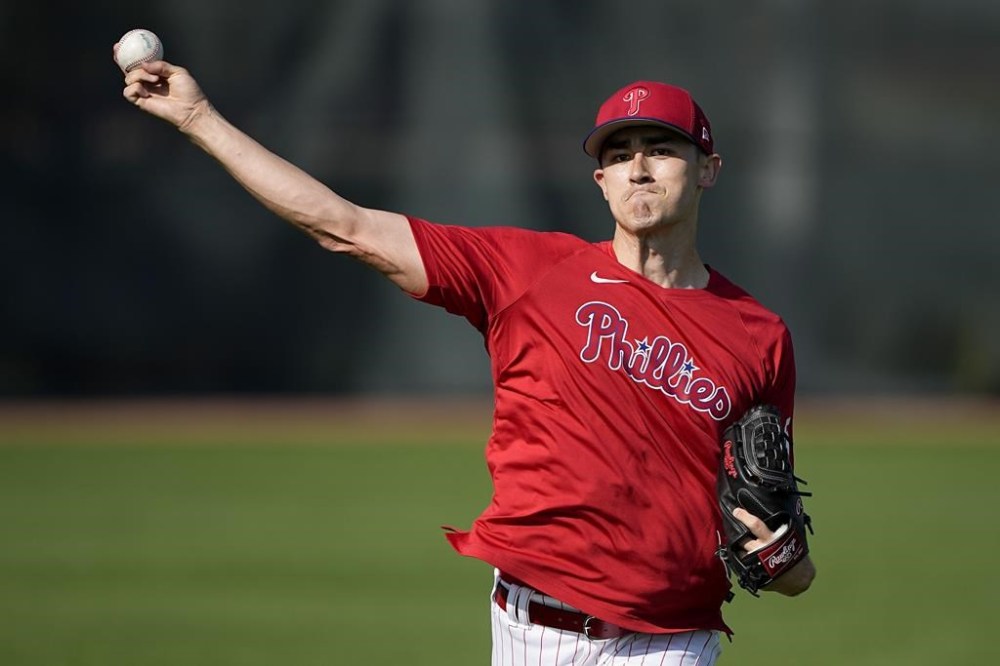 FILE - Philadelphia Phillies pitcher Noah Song throws in Clearwater, Fla., Feb. 23, 2023. Song pitched a perfect inning Wednesday night, June 28, for Class A Clearwater in his first game since joining the organization in February from the U.S. Navy. The 26-year-old Song reported to major league spring training after the Navy granted his transfer from active duty to the reserves. (AP Photo/Chris Carlson)