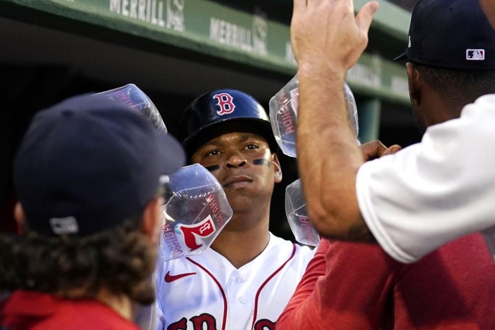 Boston Red Sox's Rafael Devers is congratulated after his solo home run in the fourth inning during a baseball game against the Miami Marlins at Fenway Park, Wednesday, June 28, 2023, in Boston. (AP Photo/Charles Krupa)