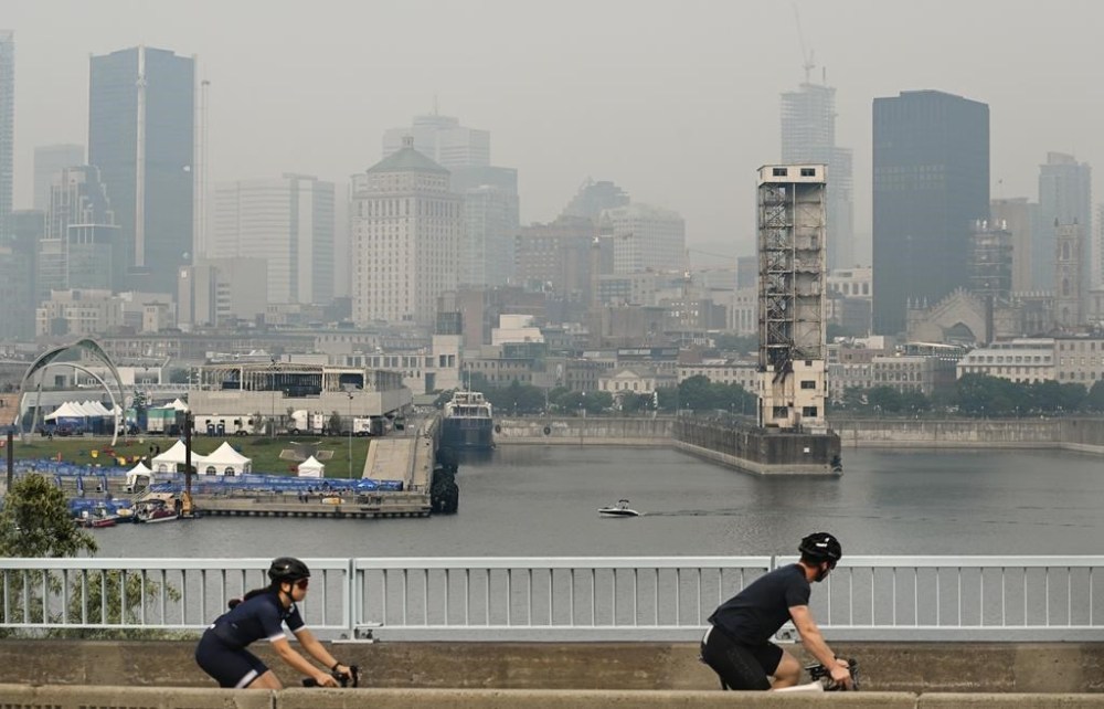 The skyline of Montreal is obscured by a haze of smoke from forest fires on Sunday, June 25, 2023. A Montreal amusement park says it is cancelling the first night of an international fireworks festival due to concerns over air quality stemming from forest fires in northern Quebec. THE CANADIAN PRESS/Graham Hughes