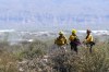 A fire crew keeps an eye on hotspots from the Diamond Fire that has burned over 2,500 acres and caused mandatory evacuations Wednesday, June 28, 2023, in Scottsdale, Ariz. (AP Photo/Ross D. Franklin)