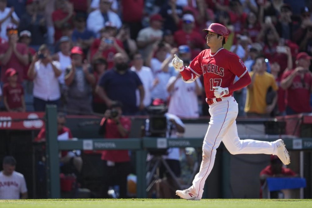 Los Angeles Angels designated hitter Shohei Ohtani (17) runs the bases after hitting a home run during the ninth inning of a baseball game against the Chicago White Sox in Anaheim, Calif., Thursday, June 29, 2023. Mike Trout also scored. (AP Photo/Ashley Landis)