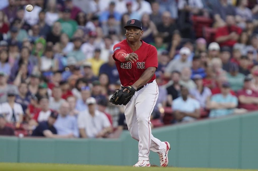 Boston Red Sox's Rafael Devers throws to first for the out on Miami Marlins' Nick Fortes during the sixth inning of a baseball game Thursday, June 29, 2023, in Boston. (AP Photo/Steven Senne)