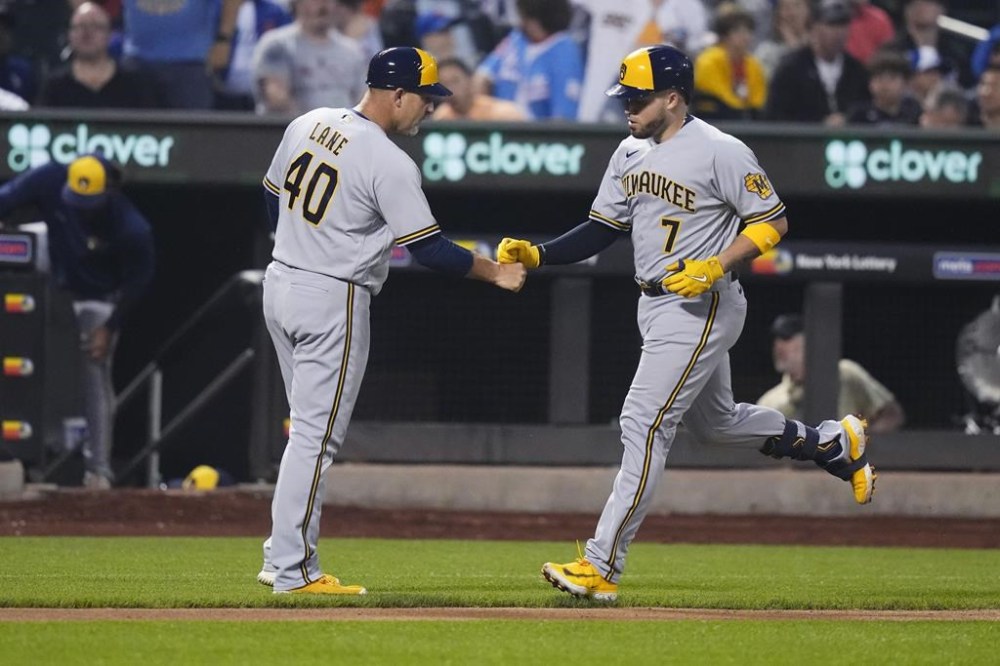 Milwaukee Brewers' Victor Caratini (7) celebrates with third base coach Jason Lane (40) as he runs the bases on a two-run home run against the New York Mets during the sixth inning of a baseball game Thursday, June 29, 2023, in New York. (AP Photo/Frank Franklin II)