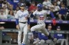 Los Angeles Dodgers' Mookie Betts dashes past third base coach Dino Ebel to score on a single by Freddie Freeman against the Colorado Rockies during the fifth inning of a baseball game Thursday, June 29, 2023, in Denver. (AP Photo/David Zalubowski)
