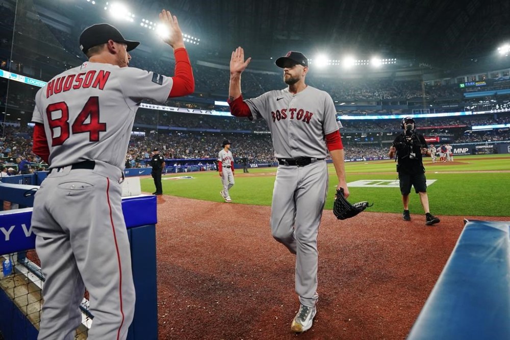 Boston Red Sox starting pitcher James Paxton (65) is congratulated by third base coach Kyle Hudson (84) as he exits the game during eighth inning American League MLB baseball action against the Toronto Blue Jays in Toronto, on Friday, June 30, 2023.THE CANADIAN PRESS/Chris Young