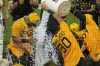Pittsburgh Pirates' Carlos Santana, left, is doused with ice water after hitting a two-run walkoff home run off Milwaukee Brewers relief pitcher Matt Bush during the bottom of the ninth inning of a baseball game in Pittsburgh, Friday, June 30, 2023. (AP Photo/Gene J. Puskar)