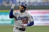Los Angeles Dodgers' Mookie Betts celebrates as he runs the bases after hitting a solo home run during the first inning of a baseball game against the Kansas City Royals Friday, June 30, 2023, in Kansas City, Mo. (AP Photo/Charlie Riedel)