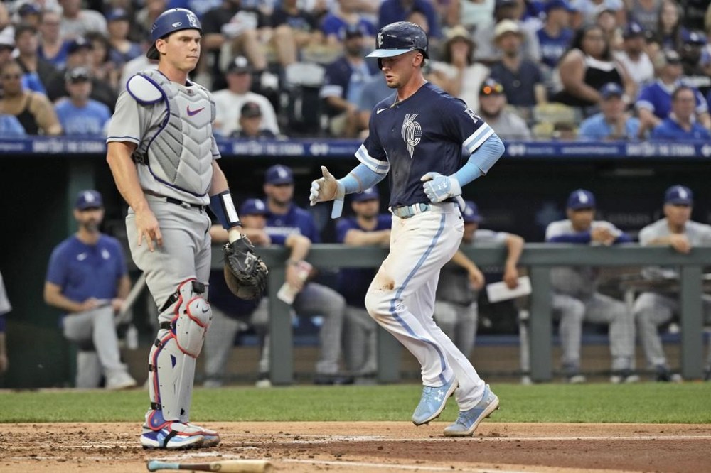Kansas City Royals' Drew Waters runs home to score past Los Angeles Dodgers catcher Will Smith on a ground out hit into by Bobby Witt Jr. during the third inning of a baseball game Friday, June 30, 2023, in Kansas City, Mo. (AP Photo/Charlie Riedel)
