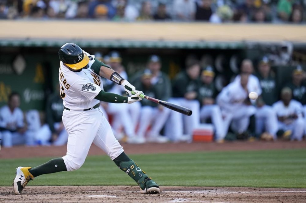 Oakland Athletics' Shea Langeliers hits an RBI single against the Chicago White Sox during the second inning of a baseball game in Oakland, Calif., Friday, June 30, 2023. (AP Photo/Godofredo A. Vásquez)