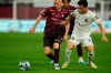 Vissel Kobe midfielder Andres Iniesta, left, vies for the ball with Consadole Sapporo midfielder Supachok Sarachat during the first half of a friendly soccer match in Kobe, Japan, Saturday, July 1, 2023. The 39-year-old Spanish footballer plays his last match for the Japanese club Saturday. (AP Photo/Hiro Komae)