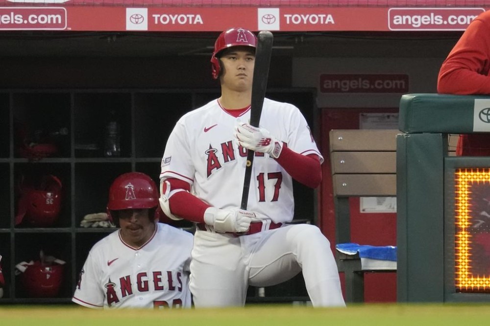 Los Angeles Angels designated hitter Shohei Ohtani (17) holds his bat in the dugout during the sixth inning of a baseball game against the Chicago White Sox in Anaheim, Calif., Monday, June 26, 2023. (AP Photo/Ashley Landis)