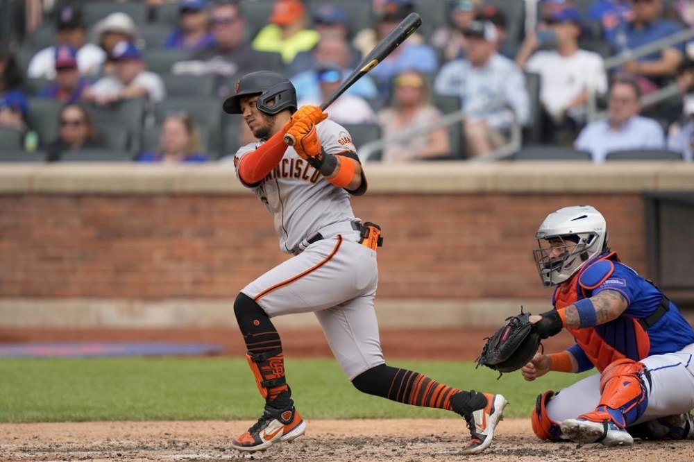 San Francisco Giants' Thairo Estrada hits an RBI sacrifice ground out against New York Mets starting pitcher Justin Verlander in the seventh inning of a baseball game, Saturday, July 1, 2023, in New York. (AP Photo/John Minchillo)