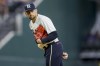 Texas Rangers pitcher Nathan Eovaldi looks to a runner on first base in the second inning of a baseball game against the Houston Astros, Saturday, July 1, 2023, in Arlington, Texas. (AP Photo/Gareth Patterson)