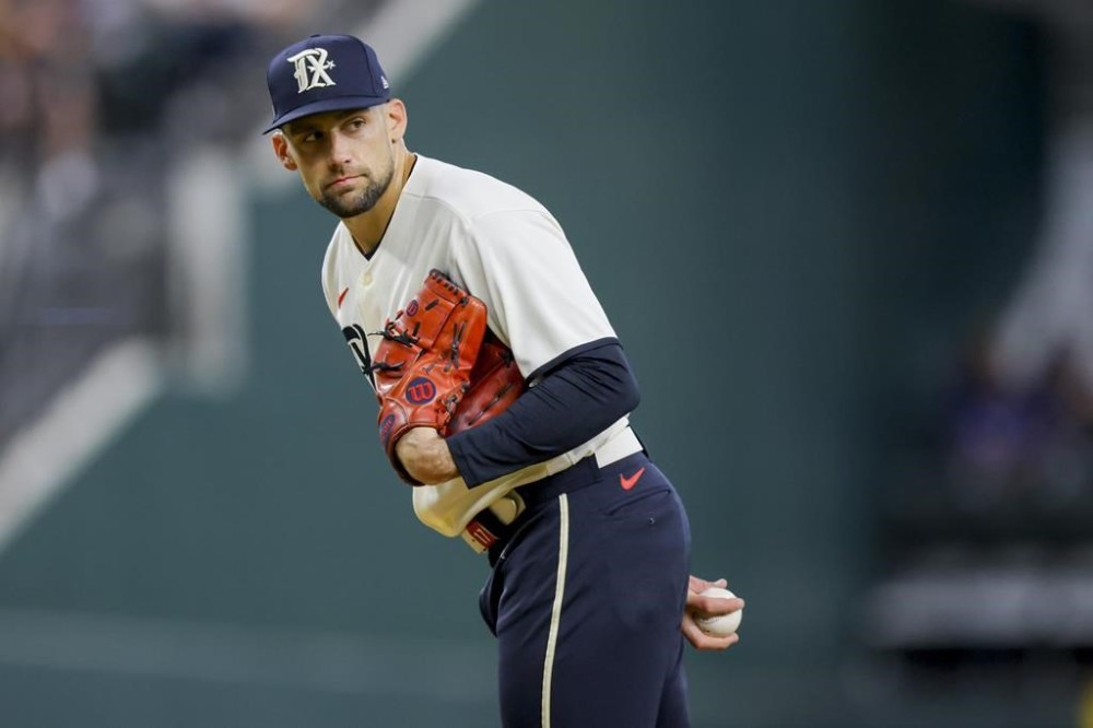 Texas Rangers pitcher Nathan Eovaldi looks to a runner on first base in the second inning of a baseball game against the Houston Astros, Saturday, July 1, 2023, in Arlington, Texas. (AP Photo/Gareth Patterson)