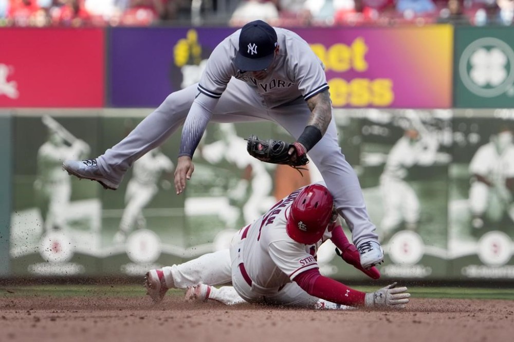 St. Louis Cardinals' Nolan Gorman, bottom, is safe at second as New York Yankees second baseman Gleyber Torres covers on a fielder's choice by Cardinals' Nolan Arenado during the third inning in the first game of a baseball doubleheader Saturday, July 1, 2023, in St. Louis. (AP Photo/Jeff Roberson)