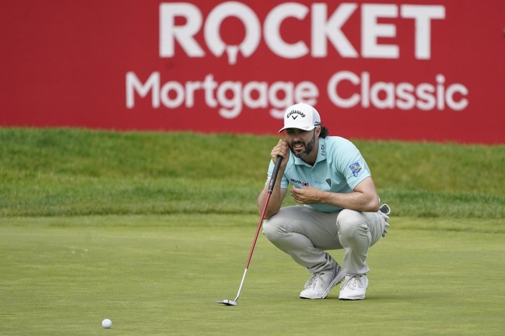 Adam Hadwin eyes his putt on the 14th green during the third round of the Rocket Mortgage Classic golf tournament at Detroit Country Club, Saturday, July 1, 2023, in Detroit. (AP Photo/Carlos Osorio)