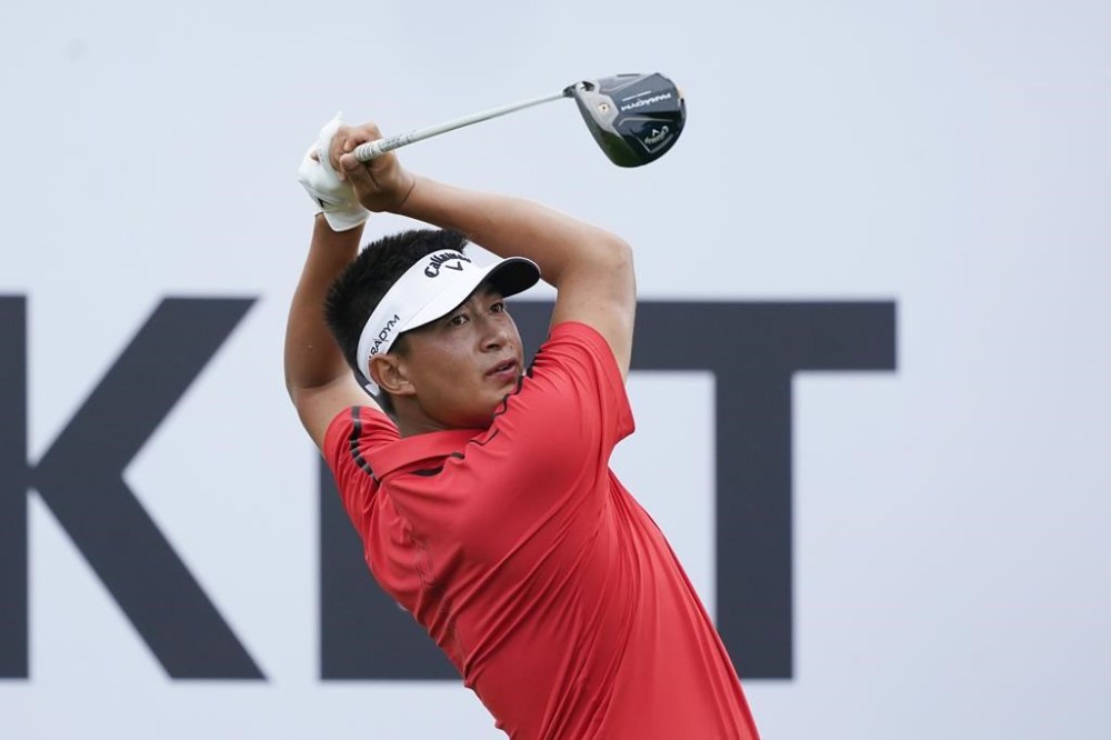 Carl Yuan drives off the 18th tee during the third round of the Rocket Mortgage Classic golf tournament at Detroit Country Club, Saturday, July 1, 2023, in Detroit. (AP Photo/Carlos Osorio)