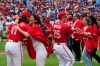 People who took part in a Canada Day citizenship ceremony and the ceremonial first pitch greet the Blue Jays players before the start of MLB AL baseball action against the Boston Red Sox in Toronto on Saturday, July 1, 2023. THE CANADIAN PRESS/Frank Gunn