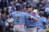 Tampa Bay Rays' Luke Raley, right, celebrates with Yandy Diaz after hitting a two-run home run off Seattle Mariners starting pitcher George Kirby, scoring Diaz, during the sixth inning of a baseball game, Saturday, July 1, 2023, in Seattle. (AP Photo/Stephen Brashear)