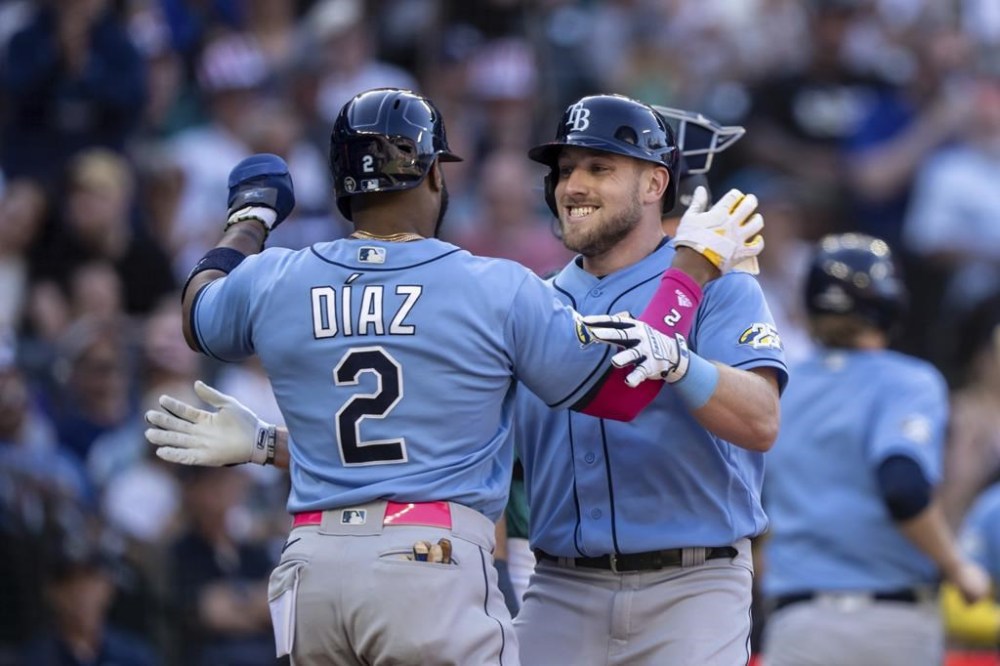 Tampa Bay Rays' Luke Raley, right, celebrates with Yandy Diaz after hitting a two-run home run off Seattle Mariners starting pitcher George Kirby, scoring Diaz, during the sixth inning of a baseball game, Saturday, July 1, 2023, in Seattle. (AP Photo/Stephen Brashear)