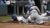 Kansas City Royals' Salvador Perez, left, beats a tag by Los Angeles Dodgers catcher Will Smith, right, to score off a Samad Taylor sacrifice fly during the first inning of a baseball game in Kansas City, Mo., Saturday, July 1, 2023. (AP Photo/Colin E. Braley)