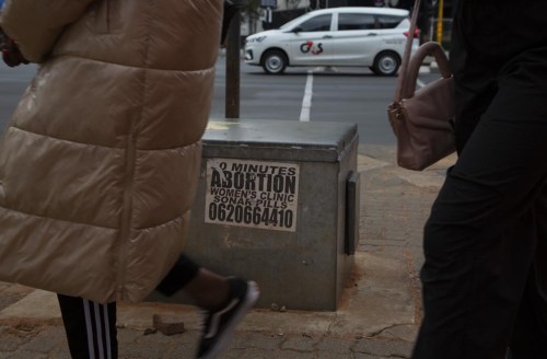 Women pass a sticker advertising abortion pills on a sidewalk in Johannesburg, Wednesday June 28, 2023. When the U.S. Supreme Court overturned the national right to an abortion a year ago, it shook efforts to legalize and make abortions safer in Africa. Sub-Saharan Africa has the world's highest rate of unintended pregnancies, and 77% of abortions are estimated to be unsafe. (AP Photo/Denis Farrell)