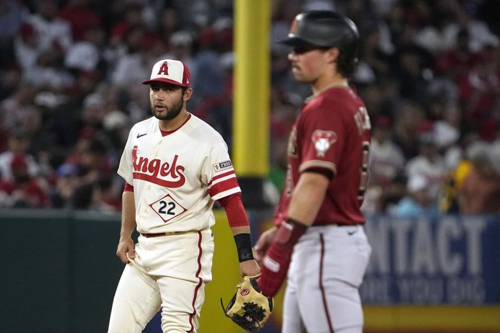 Los Angeles Angels shortstop David Fletcher, left, looks over at his brother Arizona Diamondbacks' Dominic Fletcher as Dominic stands on second during the fifth inning of a baseball game Saturday, July 1, 2023, in Anaheim, Calif. (AP Photo/Mark J. Terrill)