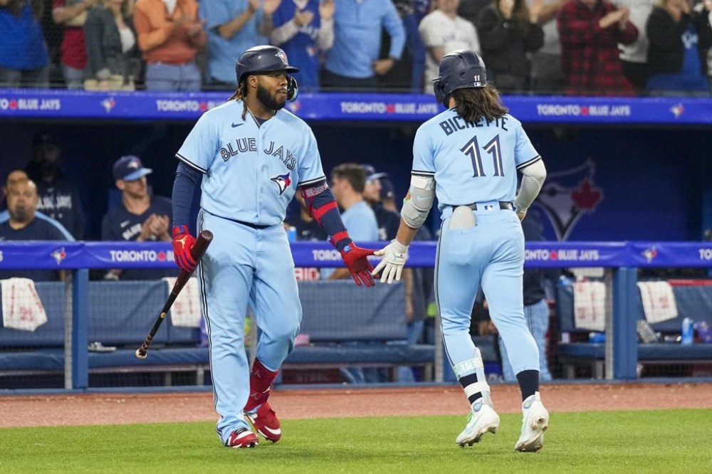 Toronto Blue Jays shortstop Bo Bichette (11) celebrates his home run against the Houston Astros with teammate first baseman Vladimir Guerrero Jr. (27) in eighth inning American League MLB baseball action in Toronto on Tuesday, June 6, 2023. Bichette and Guerrero Jr. are among four Toronto Blue Jays who were named to Major League Baseball's all-star game.THE CANADIAN PRESS/Andrew Lahodynskyj