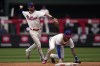 Philadelphia Phillies shortstop Trea Turner, left, throws over second baseman Bryson Stott after fielding a ground out by Washington Nationals' Ildemaro Vargas during the third inning of a baseball game, Sunday, July 2, 2023, in Philadelphia. (AP Photo/Matt Slocum)