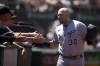 Chicago White Sox's Jake Burger (30) is congratulated by his teammates after hitting a solo home run against the Oakland Athletics during the seventh inning of a baseball game, Sunday, July 2, 2023, in Oakland, Calif. (AP Photo/D. Ross Cameron)