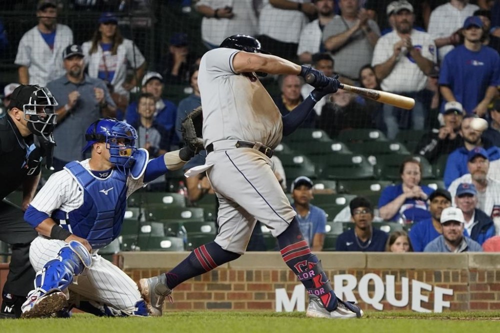 Cleveland Guardians' Josh Naylor hits a two-run single against the Chicago Cubs during the 10th inning of a baseball game, Sunday, July 2, 2023, in Chicago. (AP Photo/David Banks)