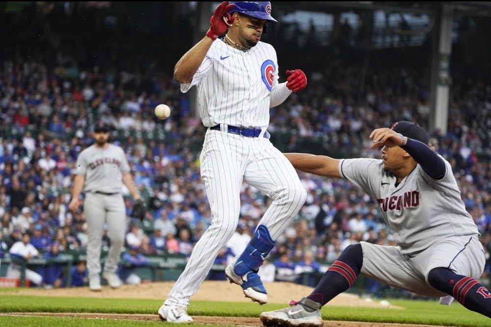 Chicago Cubs' Christopher Morel, front left, is safe at first base with a single as Cleveland Guardians first baseman Josh Naylor, right, tries to catch a throw during the third inning of a baseball game game Sunday, July 2, 2023, in Chicago. (AP Photo/David Banks)