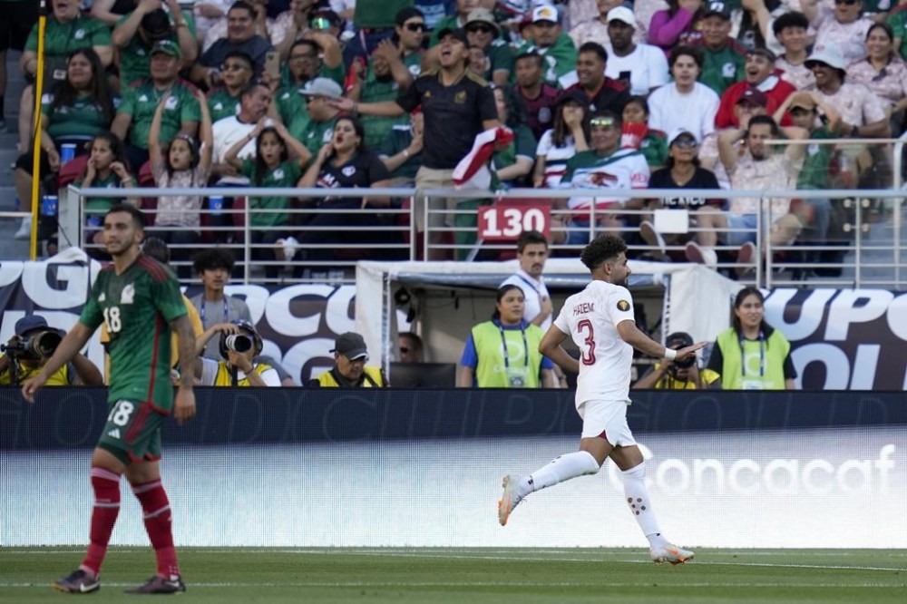 Qatar defender Hazem Shehata, right, celebrates after scoring a goal against the Mexico during the first half of a CONCACAF Gold Cup soccer match, Sunday, July 2, 2023, in Santa Clara, Calif. (AP Photo/Godofredo A. Vásquez)