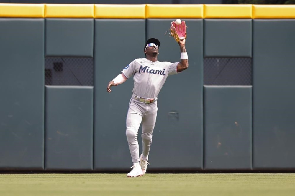 Miami Marlins center fielder Jazz Chisholm Jr. catches a fly ball by Atlanta Braves center fielder Michael Harris II in the first inning during a baseball game Saturday, July 1, 2023, in Atlanta. (AP Photo/Alex Slitz)