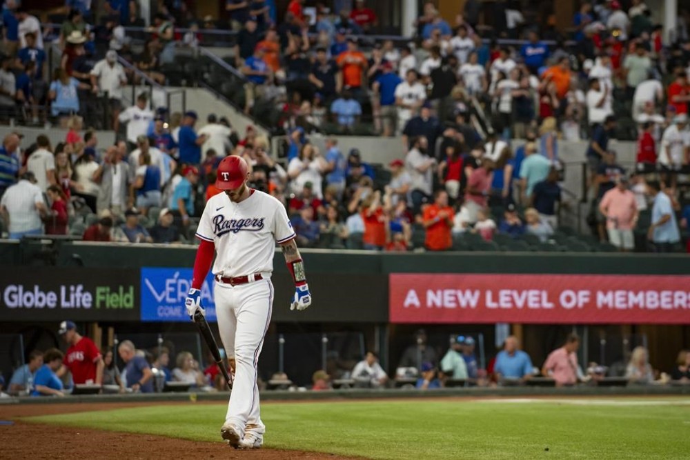 Texas Rangers' Jonah Heim walks off of the field after striking out in the bottom of the ninth inning in a baseball game against the Houston Astros in Arlington, Texas, Monday, July 3, 2023. (AP Photo/Emil T. Lippe)