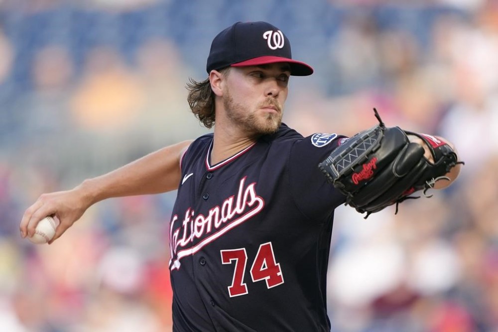 Washington Nationals starting pitcher Jake Irvin throws to the Cincinnati Reds in the first inning of a baseball game, Monday, July 3, 2023, in Washington. (AP Photo/Patrick Semansky)