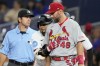 Miami Marlins' Luis Arraez, center, hugs St. Louis Cardinals first baseman Paul Goldschmidt (46) after hitting a single during the first inning of a baseball game, Monday, July 3, 2023, in Miami. (AP Photo/Lynne Sladky)