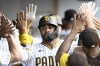 San Diego Padres' Xander Bogaerts is congratulated after hitting a three-run home run during the first inning of a baseball game against the Los Angeles Angels, Monday, July 3, 2023, in San Diego. (AP Photo/Denis Poroy),