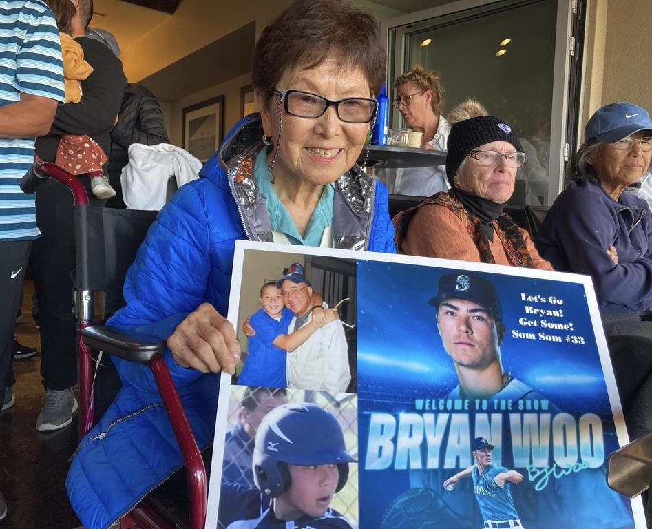 The grandmother of Seattle Mariners rookie pitcher Bryan Woo poses for a photo in San Francisco during a baseball game between the Mariners and the San Francisco Giants, Monday, July 3, 2023. Nancy, 85, center, is from El Cerrito, Calif., and is getting to see her grandson pitch back home in the Bay Area where he grew up in Alameda. (AP Photo/Janie McCauley)
