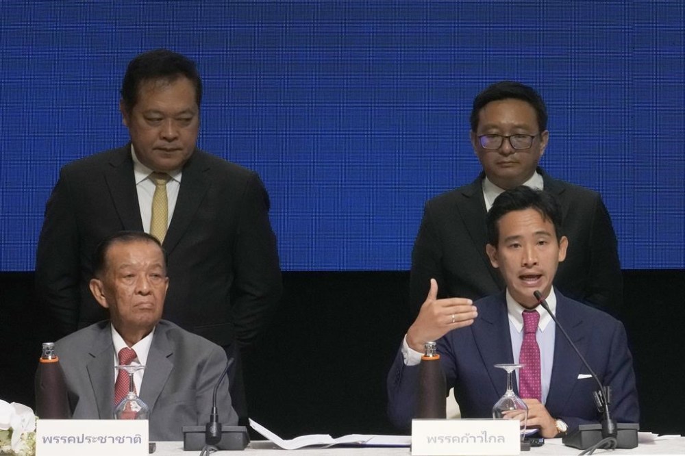 FILE - Leader of the Move Forward Party Pita Limjaroenrat, right, with leader of the Prachachat Party Wan Muhamad Noor Matha, left, talks to reporter before signing a memorandum of understanding on attempt to form a coalition government between the Move Forward Party and other parties during a news conference in Bangkok, Thailand, on May 22, 2023. Thailand's new government took a step closer to forming with the speaker of the House of Representative chosen Tuesday, July 4, in what has been an arduous task before the next prime minister is named. (AP Photo/Sakchai Lalit, File)