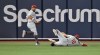 Philadelphia Phillies left fielder Kyle Schwarber watches as center fielder Brandon Marsh (16) makes a sliding catch on a fly ball hit by Tampa Bay Rays' Christian Bethancourt during the fifth inning of a baseball game Tuesday, July 4, 2023, in St. Petersburg, Fla. (AP Photo/Steve Nesius)